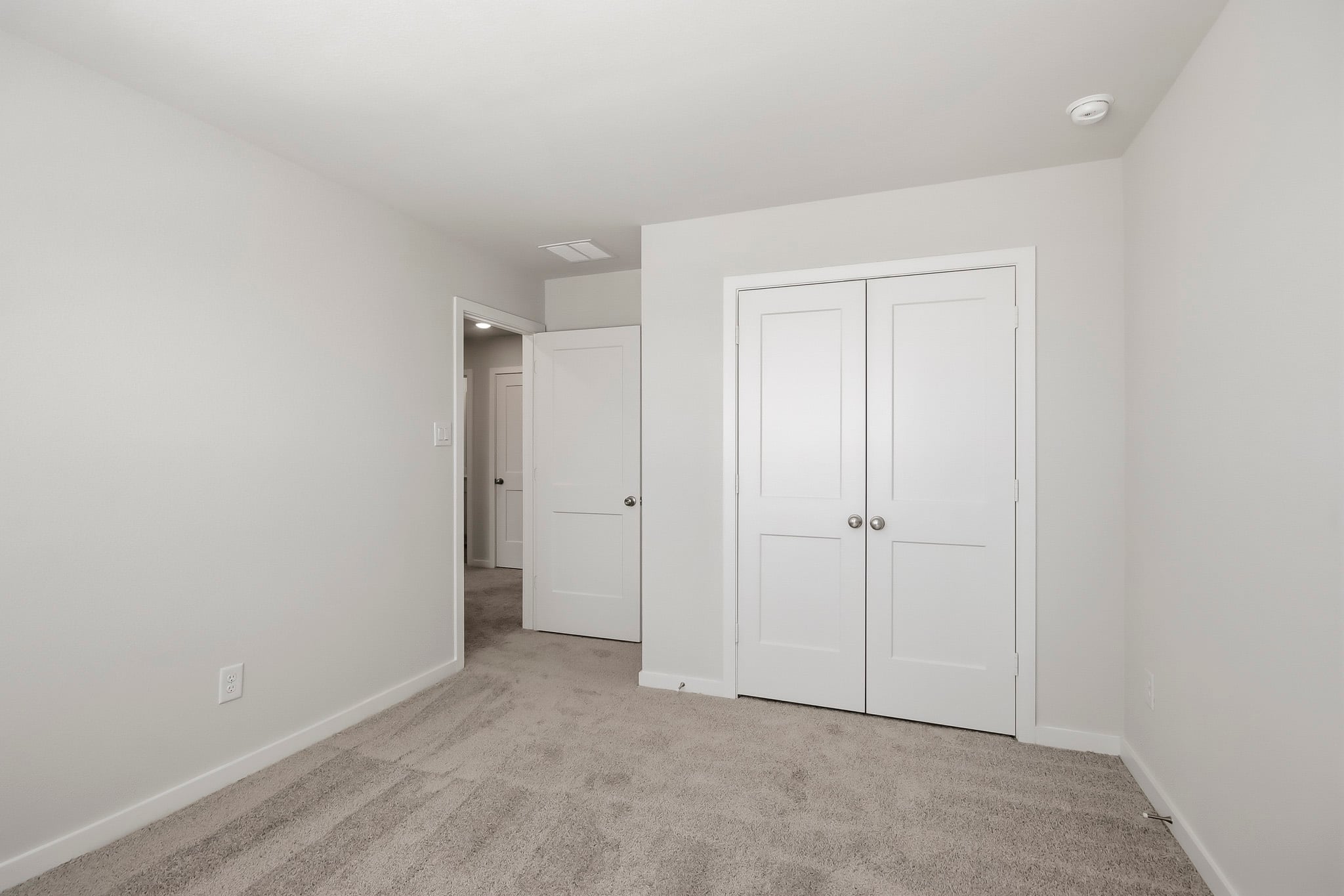 A hallway with white doors.