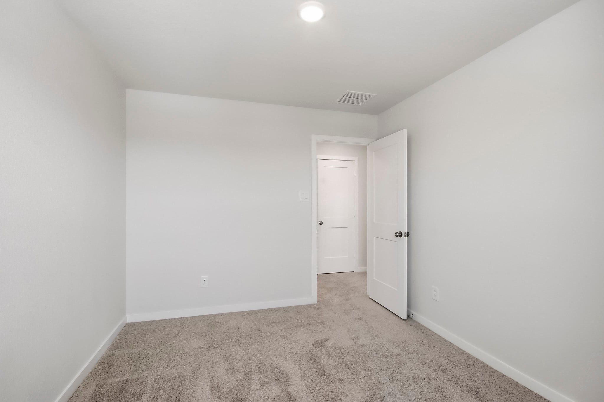 A hallway with white doors.