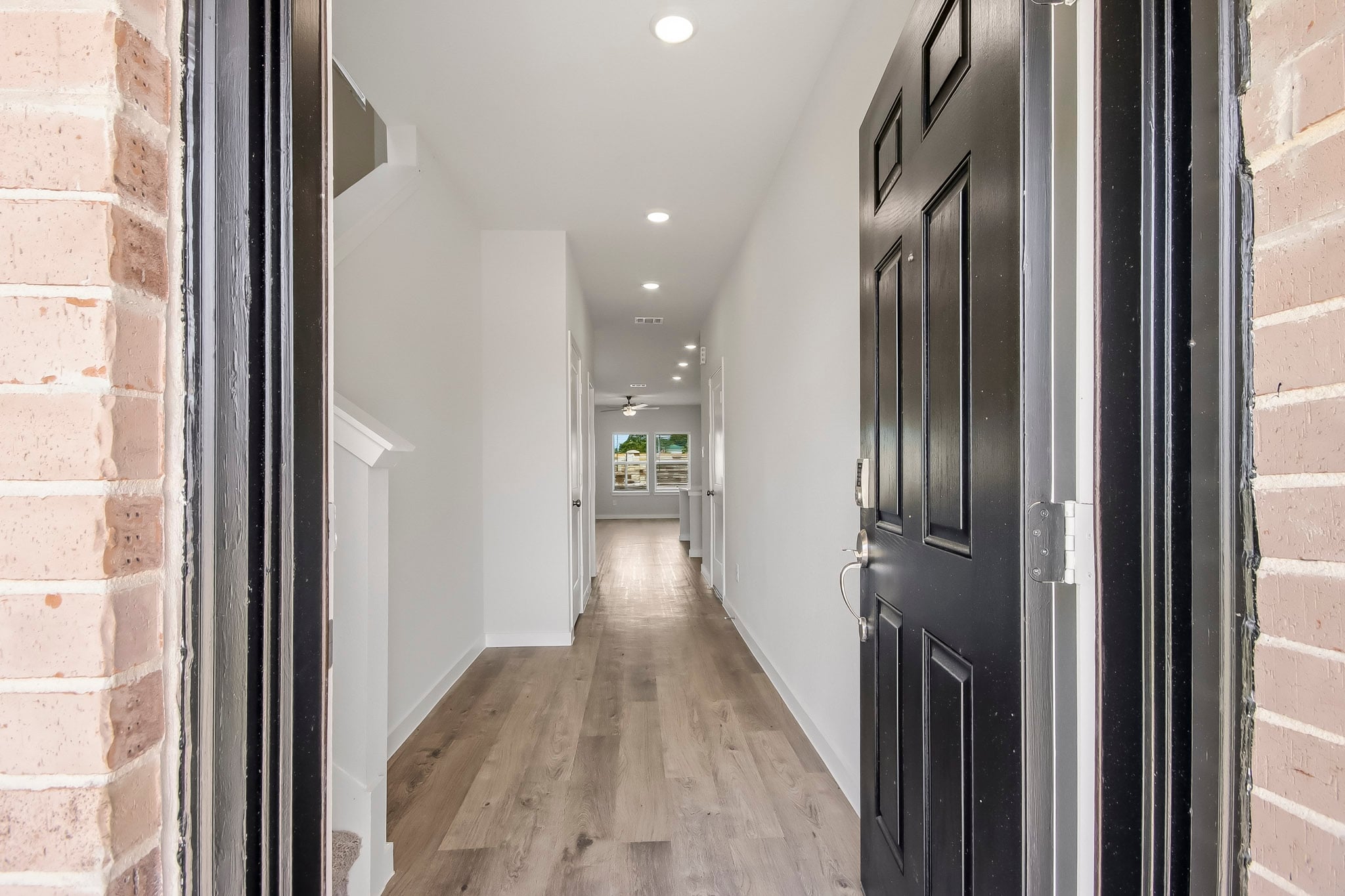 A hallway with black doors.