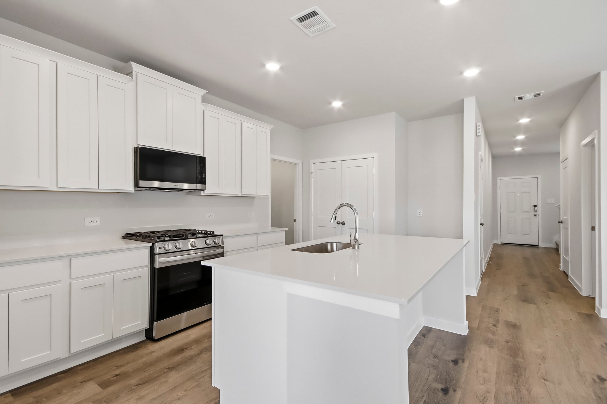 A kitchen with white cabinets.