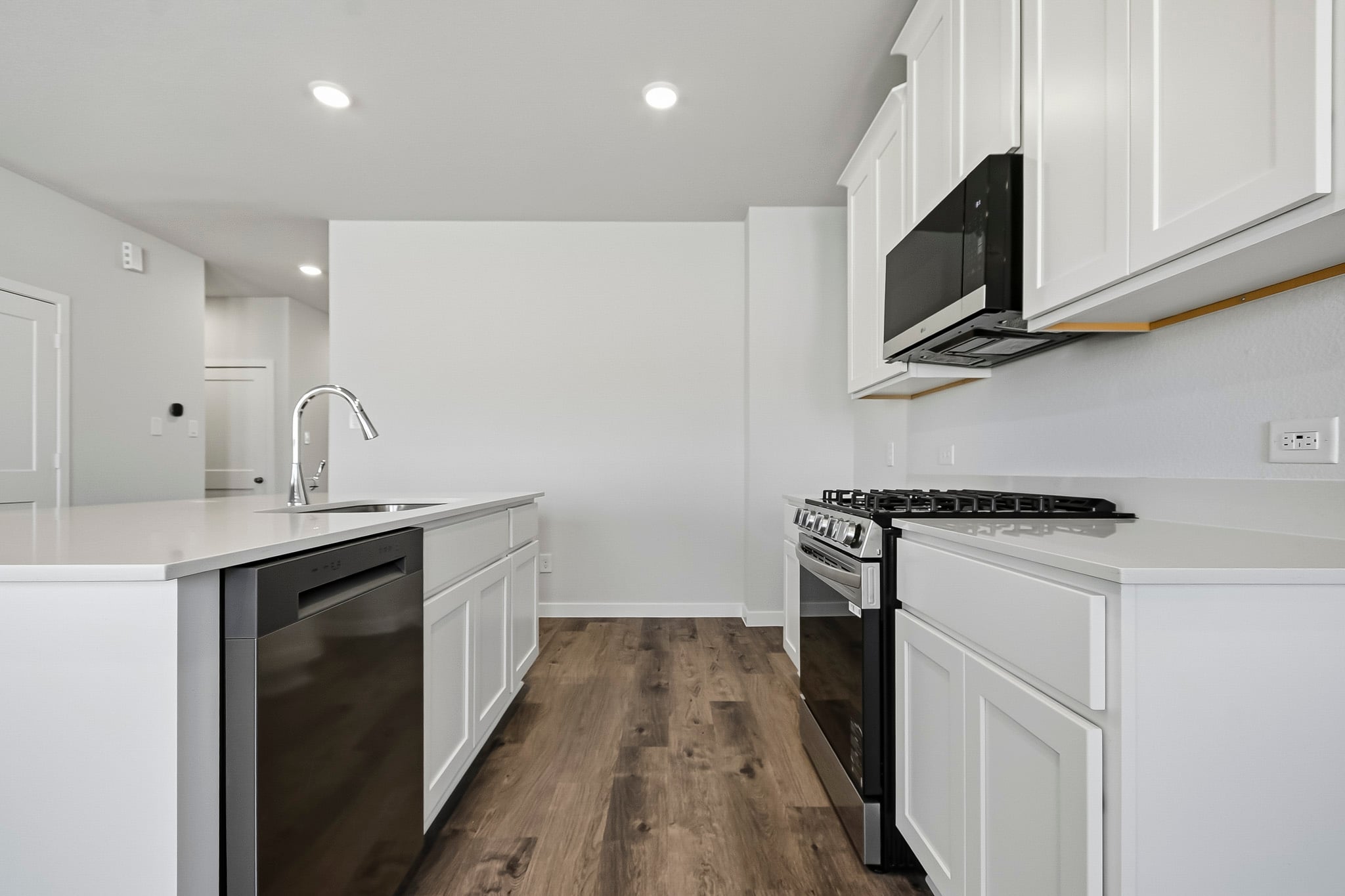 A kitchen with white cabinets.