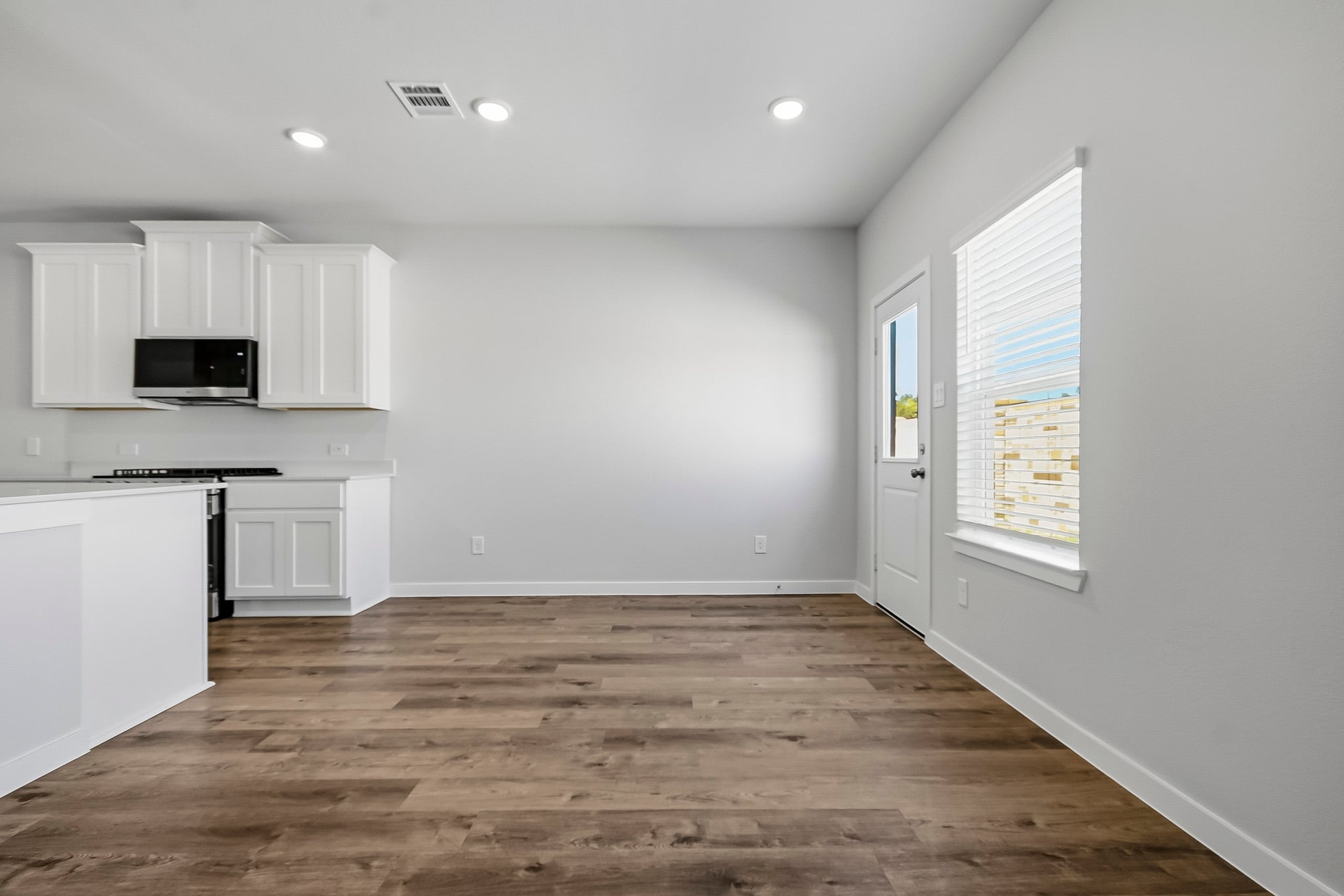 A kitchen with white cabinets.