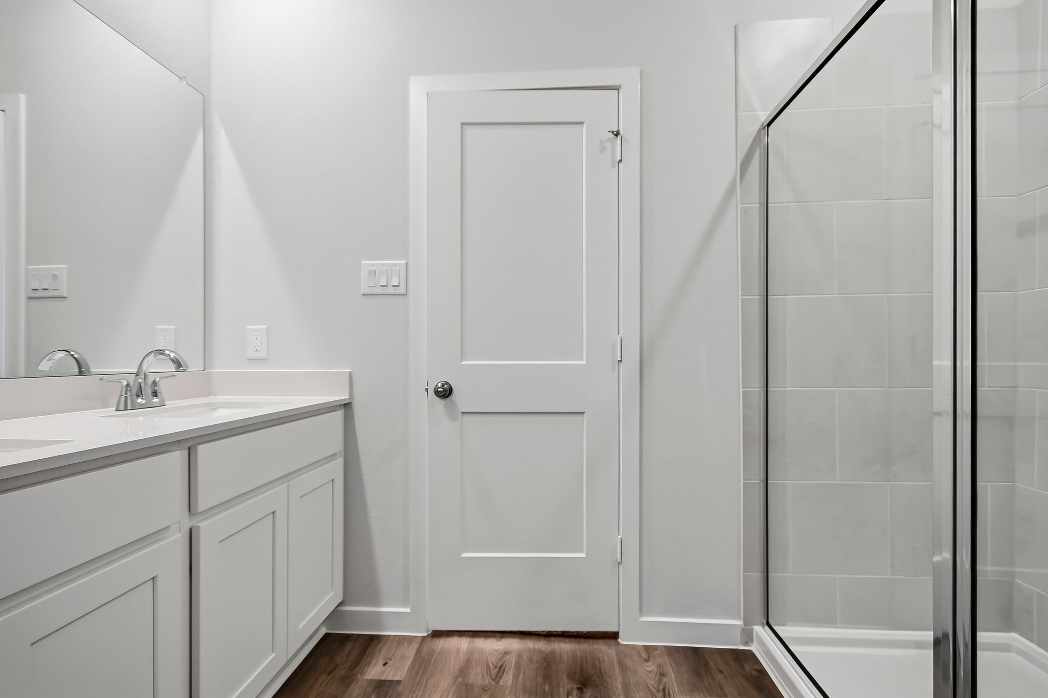 A bathroom with a glass shower.