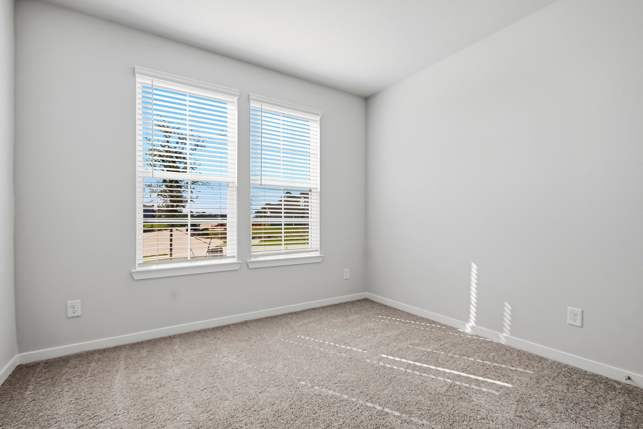 A room with a window and a carpet.