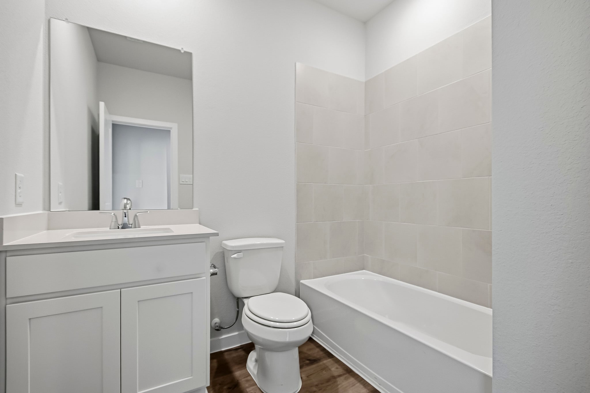 A bathroom with a tub toilet and sink.