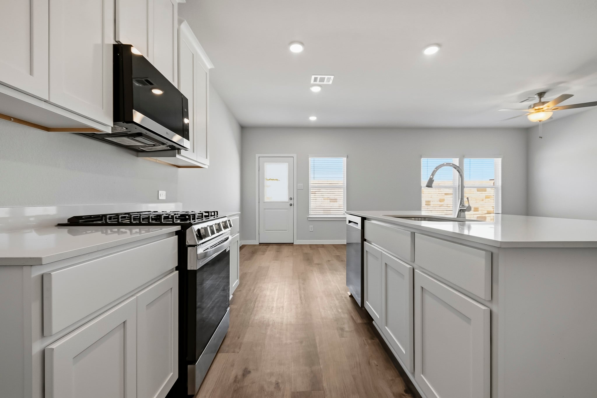 A kitchen with white cabinets.
