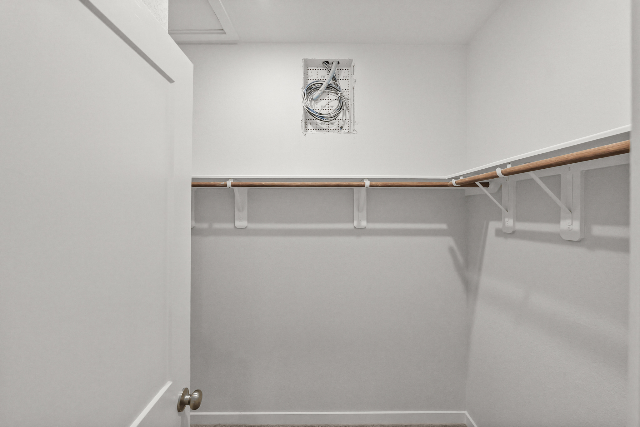 A white wall with a metal railing.