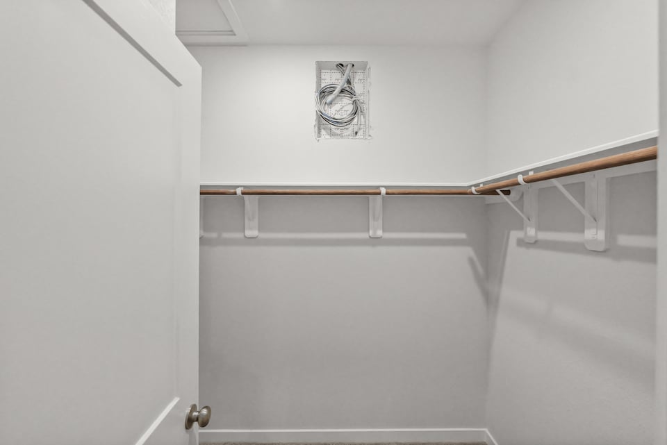 A white wall with a metal railing.