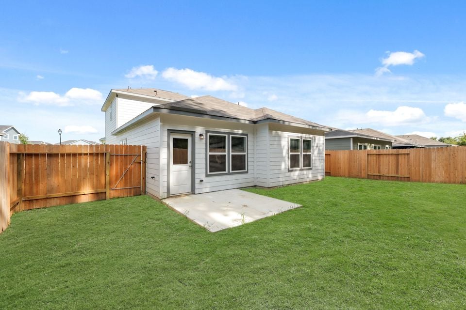 A small house with a fence.