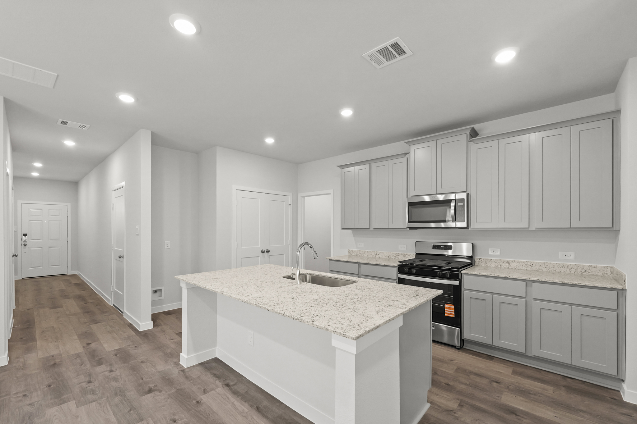 A kitchen with white cabinets.