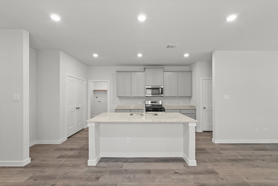 A kitchen with white cabinets.