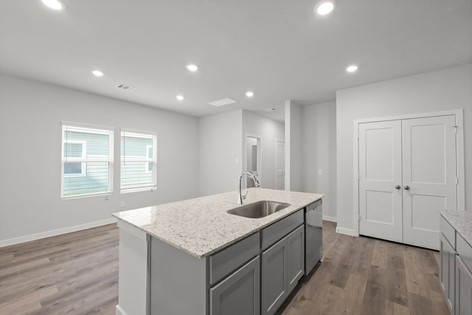 A kitchen with a marble countertop.
