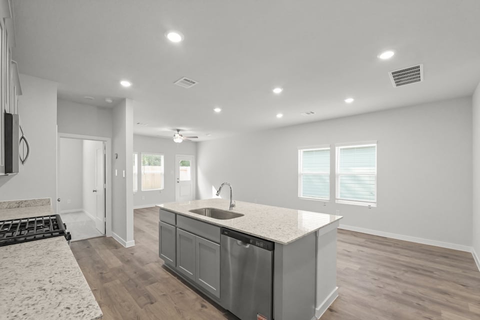 A kitchen with a marble countertop.