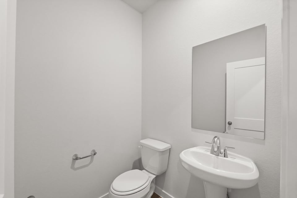 A bathroom with a toilet and sink.