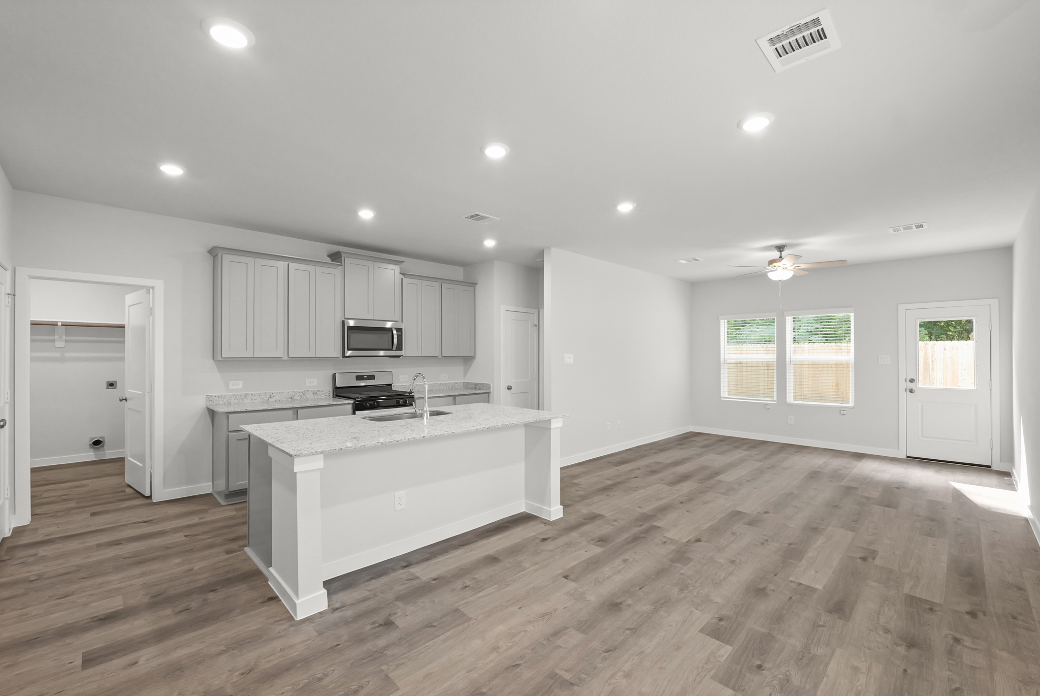A kitchen with white cabinets.