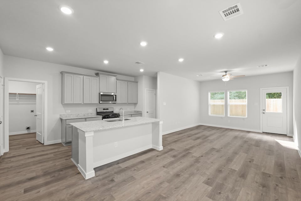 A kitchen with white cabinets.