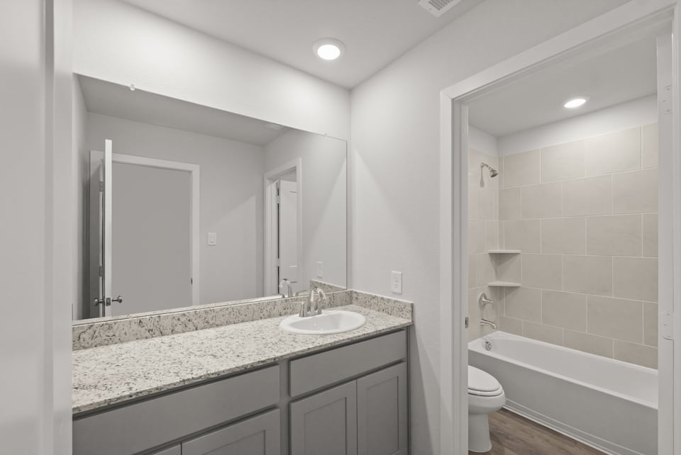 A bathroom with a marble countertop.