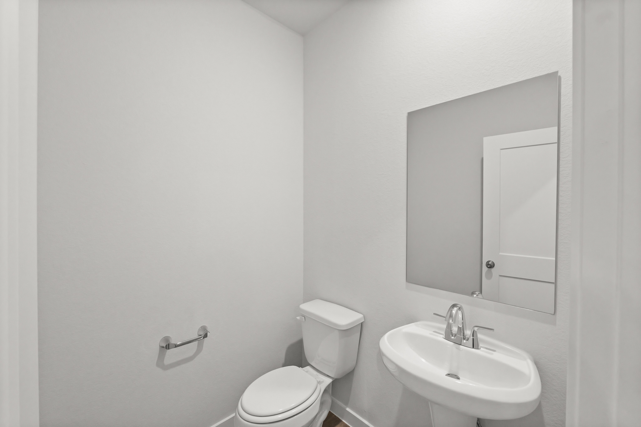 A bathroom with a toilet and sink.