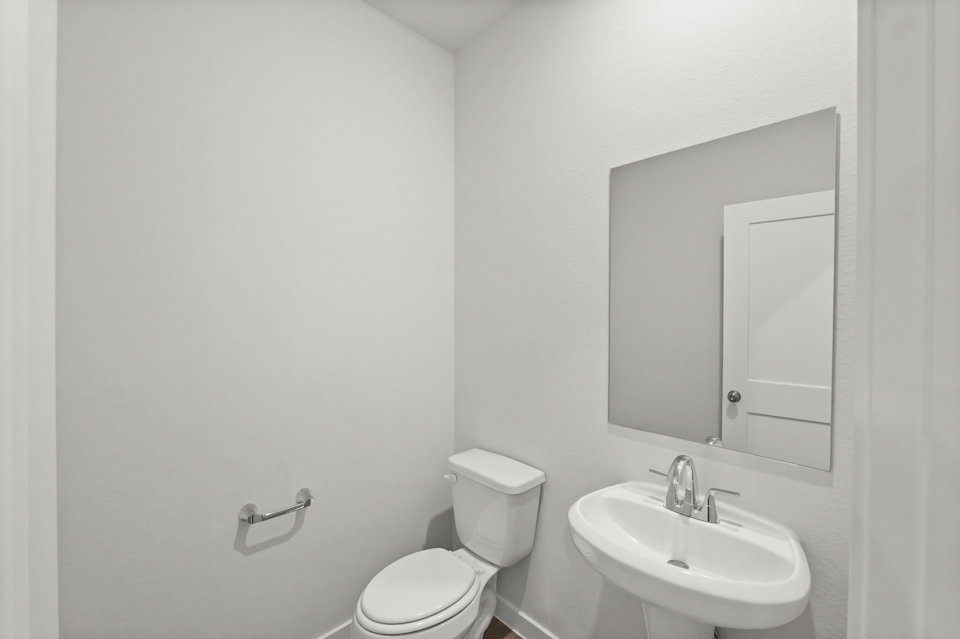 A bathroom with a toilet and sink.