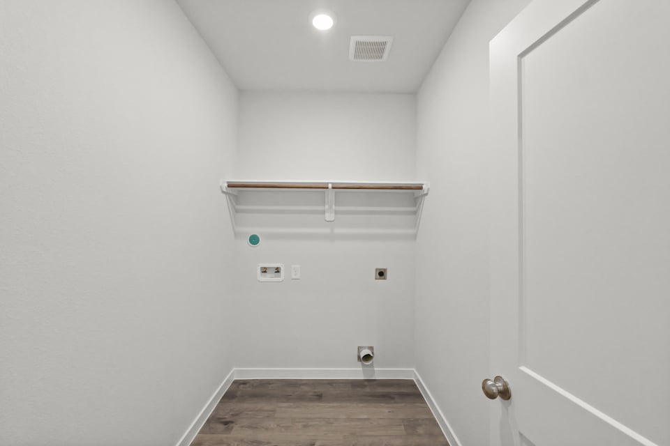 A room with a wood floor and a white door.
