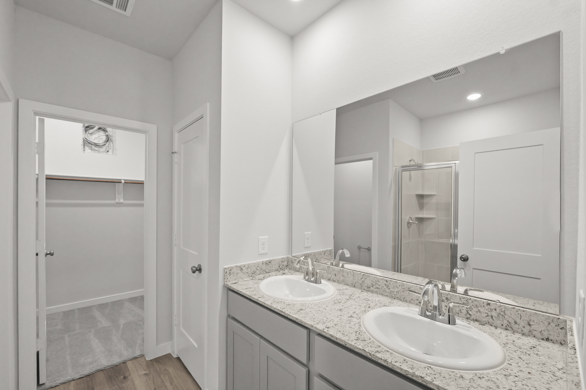 A bathroom with a large mirror.