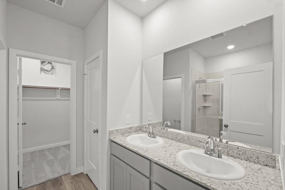 A bathroom with a large mirror.