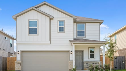 A white house with a garage.
