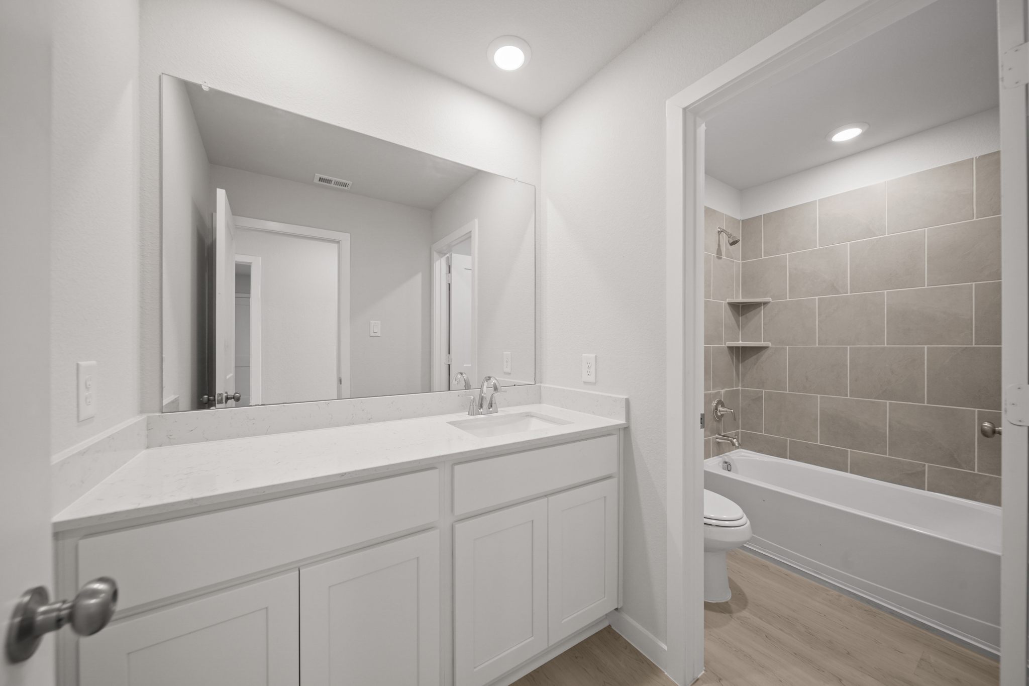 A bathroom with a tub sink and toilet.