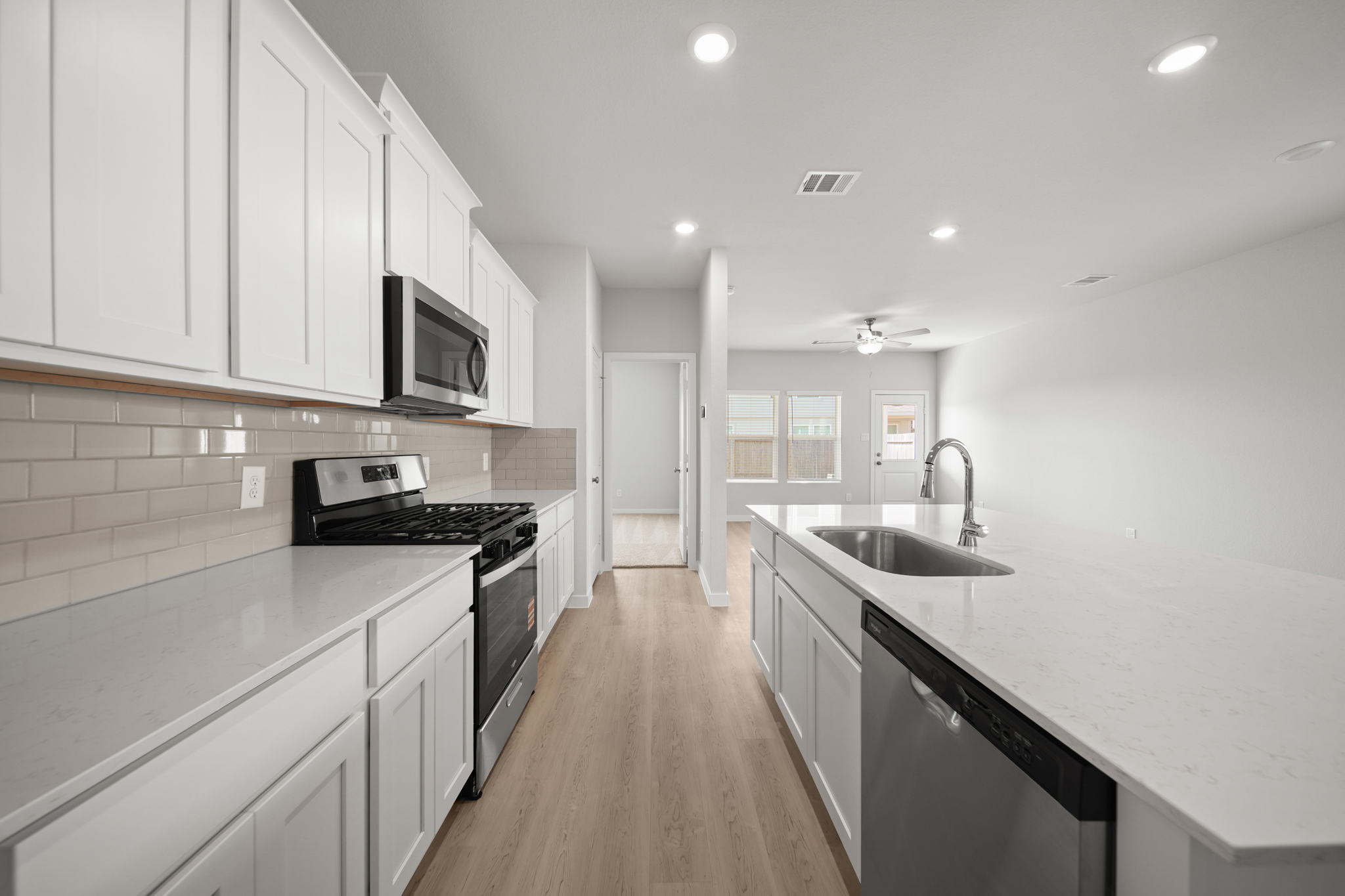 A kitchen with white cabinets.