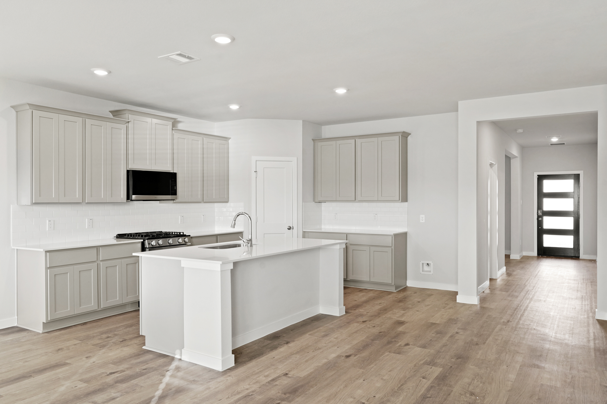 A kitchen with white cabinets.