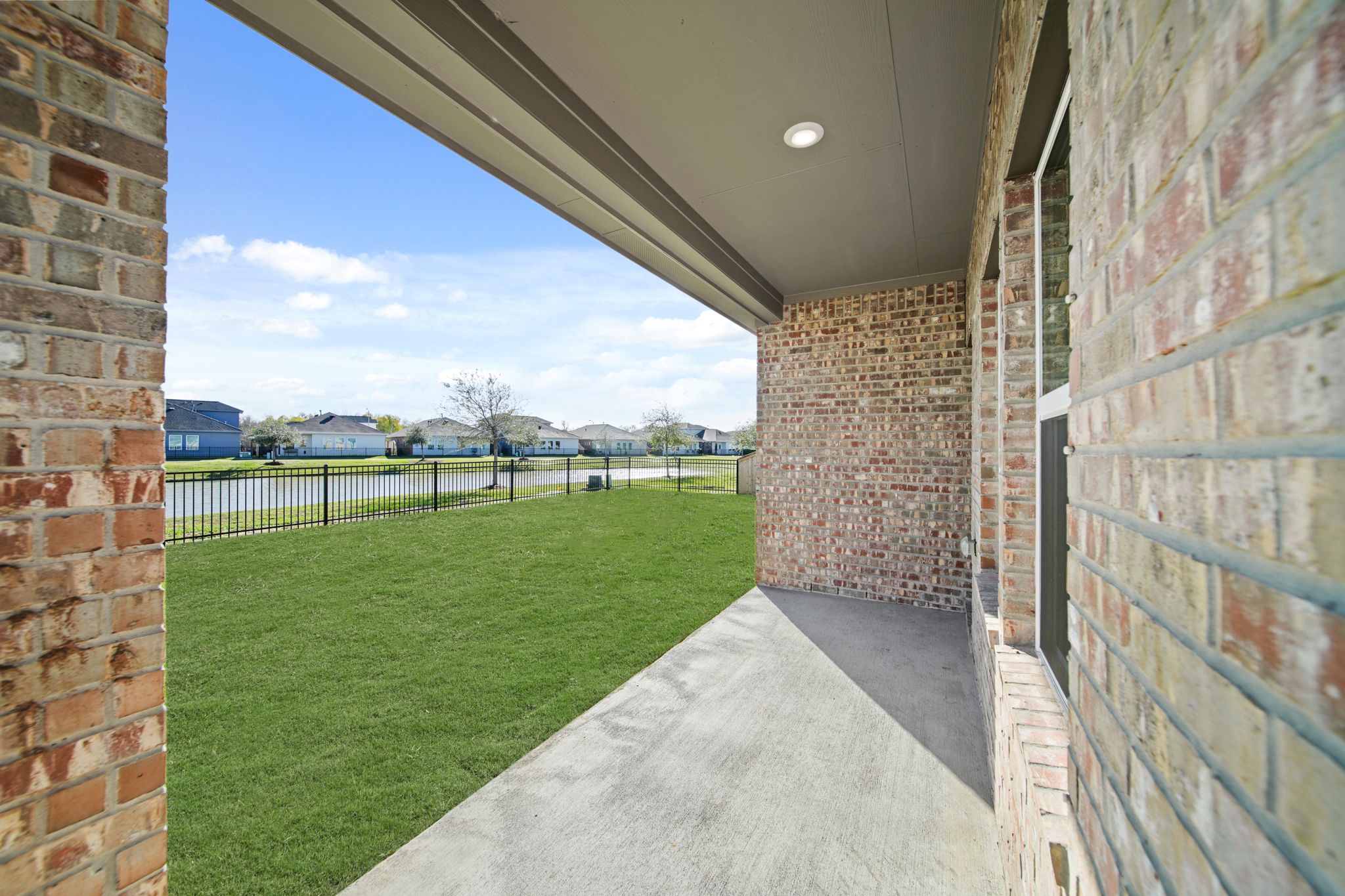 A walkway between brick walls.