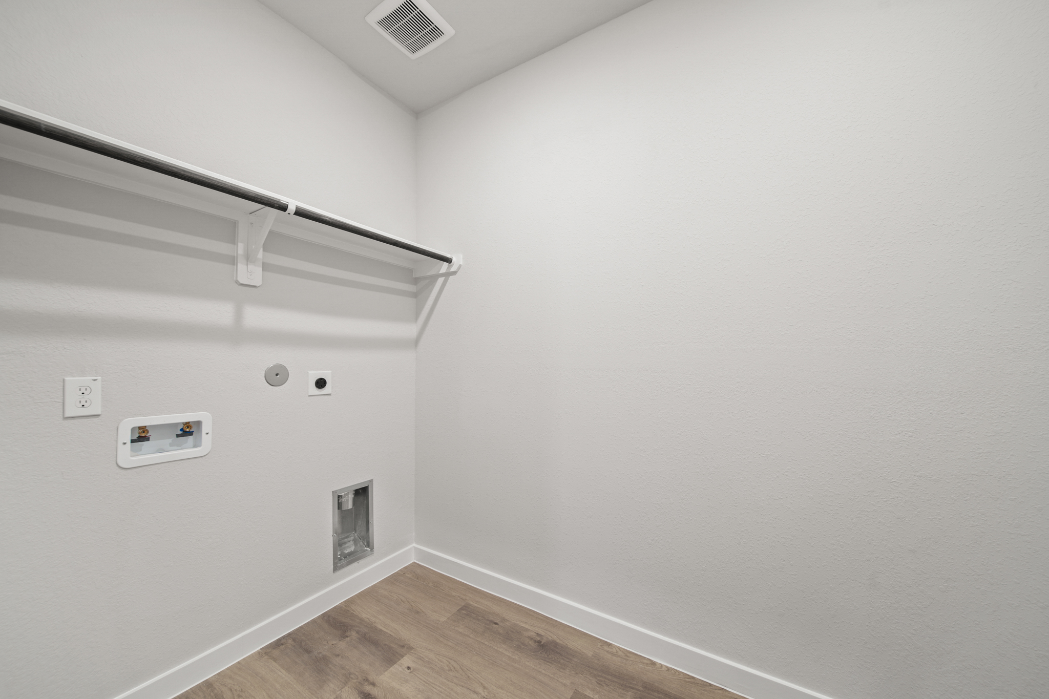 A white room with a wood floor.