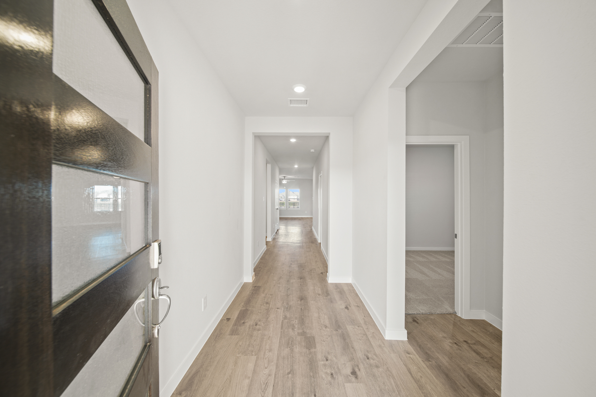 A long hallway with white walls.