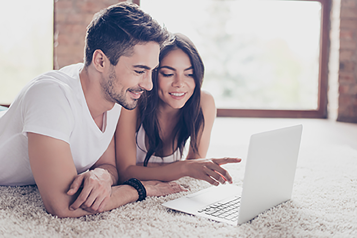 A man and a woman looking at a laptop.
