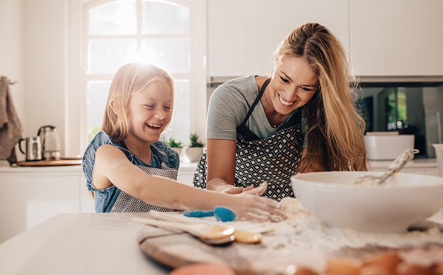 mom and daughter in kitchen-637322474