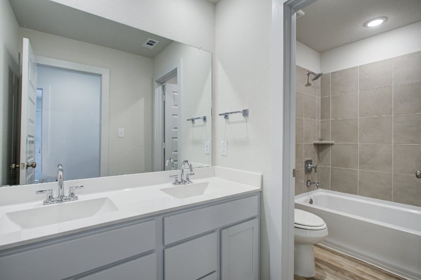 A bathroom with a tub sink and toilet.