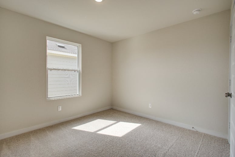 A room with a door and a rug.