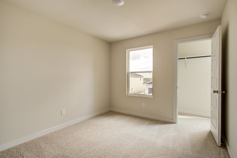 A room with a window and a door.