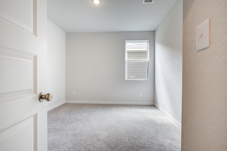 A hallway with white doors.