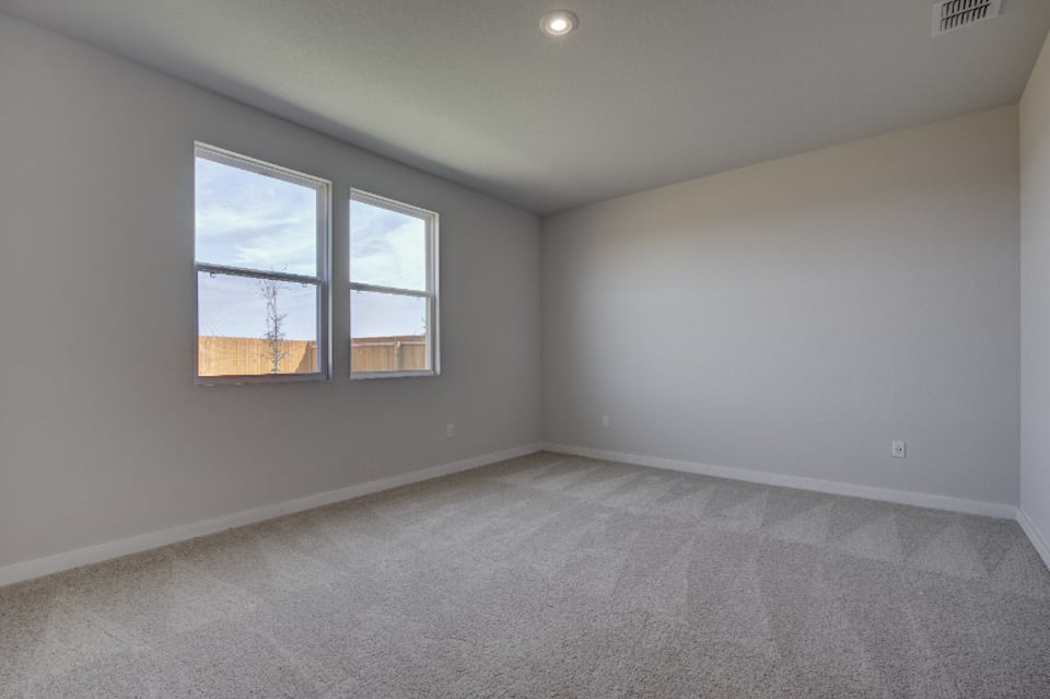 A room with a window and a carpet.