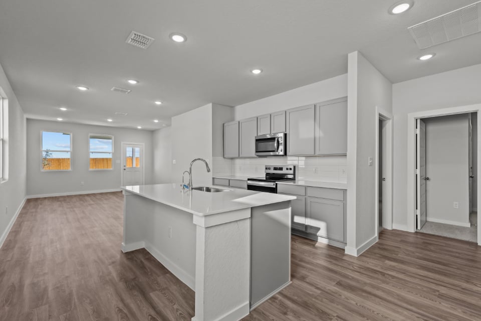 A kitchen with white cabinets.