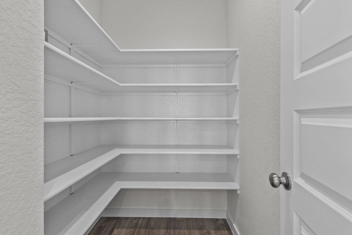 A white staircase with white walls.