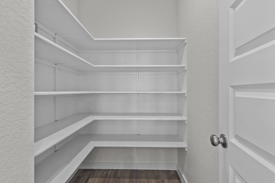 A white staircase with white walls.
