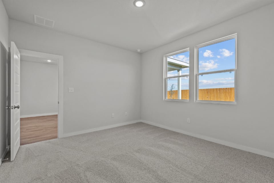 A room with a window and a door.