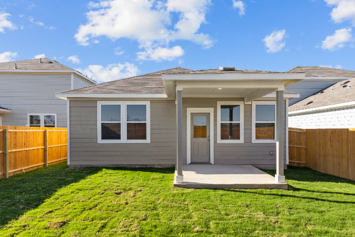A house with a fence and grass.