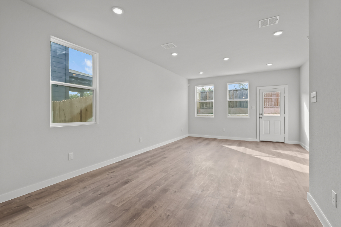 A room with a wood floor and white walls.