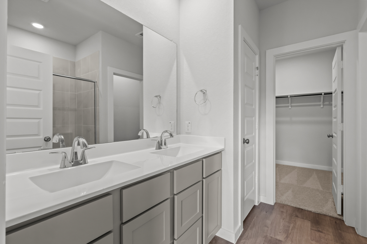 A bathroom with a sink and a shower.