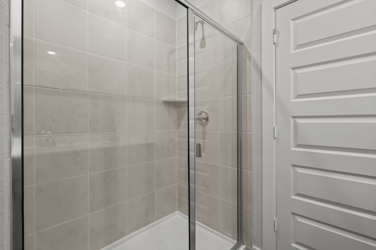 A shower with a glass door.