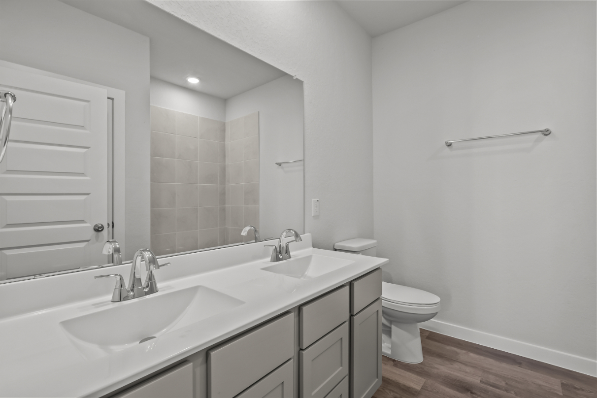A bathroom with a tub sink and toilet.