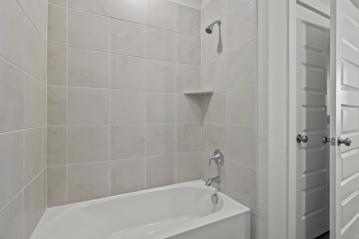 A bathtub in a bathroom.